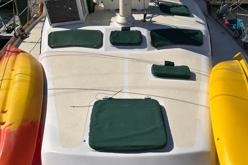 Slide: The Image of Deck of 1986 Irwin 43 Mk II Cruiser with green covers and kayaks. - 23