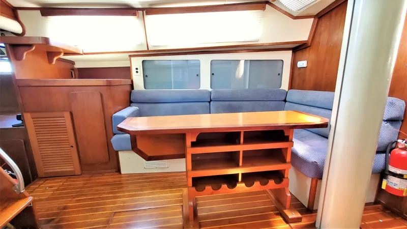 Slide: The Image of 1986 Irwin 43 Mk II Cruiser interior with wooden table and blue seating. - 6