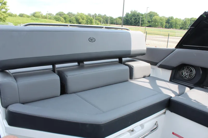 Slide: The Image of 2026 Cobalt R4 boat interior with gray cushioned seating and speaker. - 14