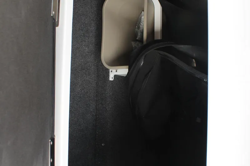 Slide: The Image of Interior storage compartment of 2026 Cobalt R4, featuring a black bag and beige container. - 16