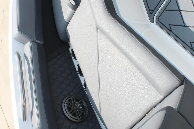 Slide: The Image of 2026 Cobalt R4 boat interior with gray seating and speaker system. - 26