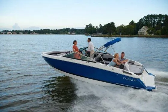 Slide: The Image of 2026 Cobalt R4 boat cruising on a lake with passengers enjoying the ride. - 34