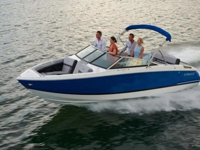Slide: The Image of 2026 Cobalt R4 boat cruising on water with four passengers enjoying the ride. - 35