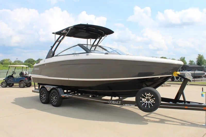 Slide: The Image of 2026 Cobalt R4 boat on trailer, parked outdoors under a cloudy sky. - 6