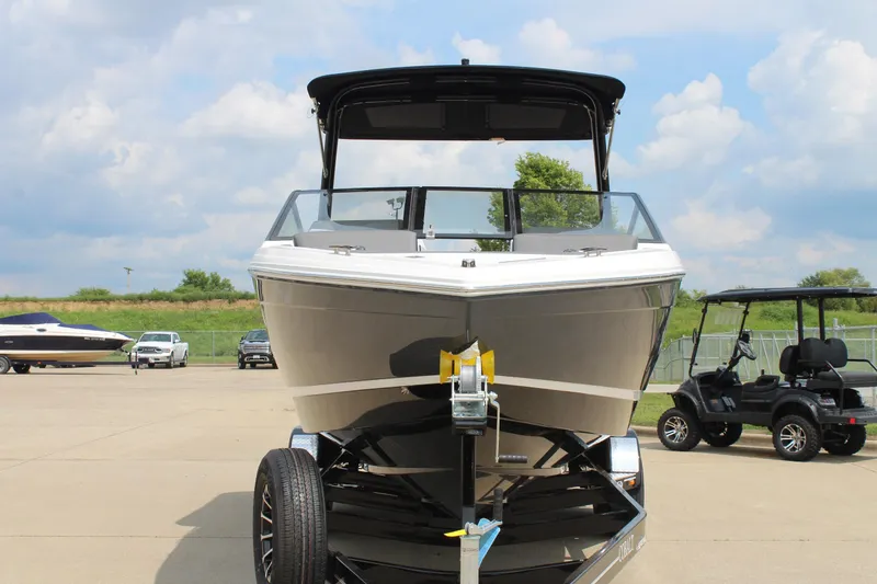 Slide: The Image of 2026 Cobalt R4 boat on trailer, parked outdoors under a cloudy sky. - 7