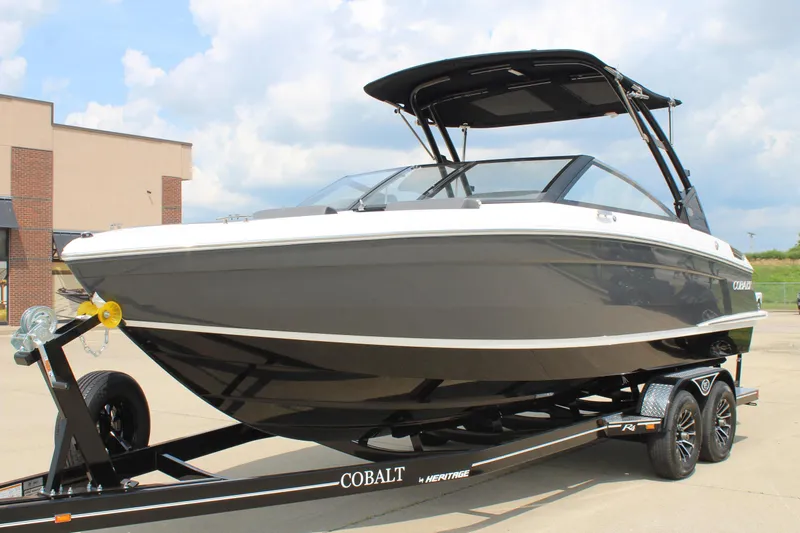 Slide: The Image of 2026 Cobalt R4 boat on trailer, sleek design, parked outdoors under cloudy sky. - 8