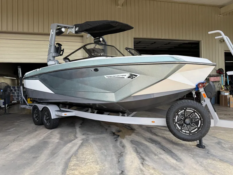 The Image of 2022 Nautique Super Air G23 boat on trailer in a garage setting. - 0