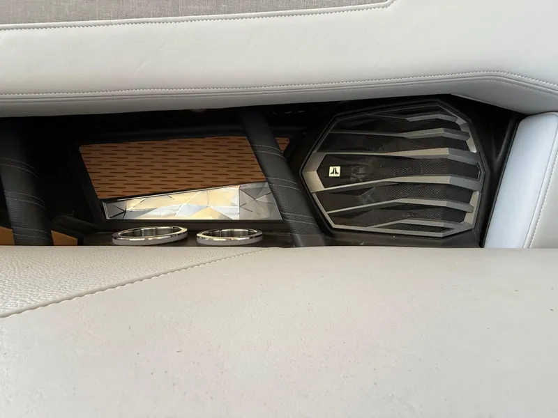 Slide: The Image of 2022 Nautique Super Air G23 interior speaker and cup holders detail. - 11