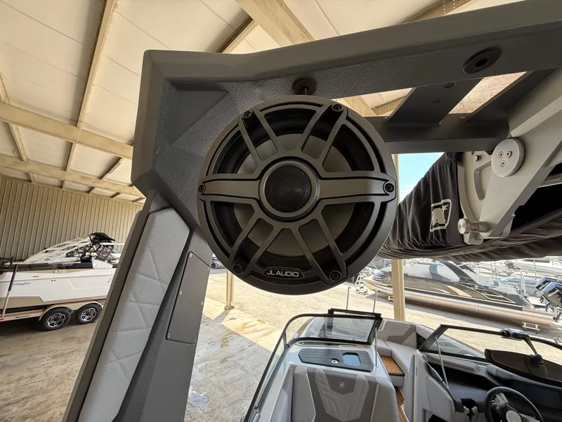 Slide: The Image of 2022 Nautique Super Air G23 boat with JL Audio speaker in a marina setting. - 14