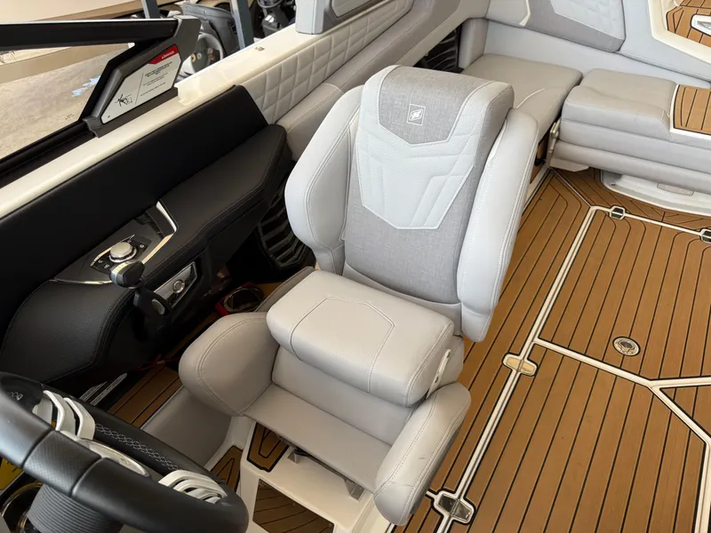 Slide: The Image of 2022 Nautique Super Air G23 interior with luxurious seating and modern dashboard design. - 16