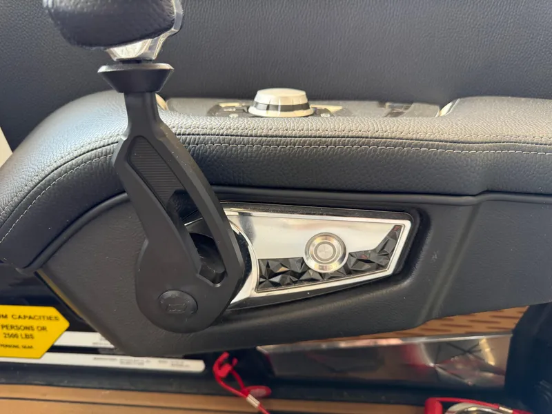 Slide: The Image of Close-up of 2022 Nautique Super Air G23 boat control panel with handle and button. - 17