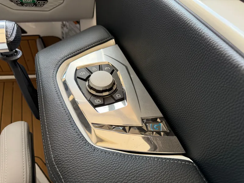 Slide: The Image of Control panel of 2022 Nautique Super Air G23 boat with sleek design and metallic finish. - 19