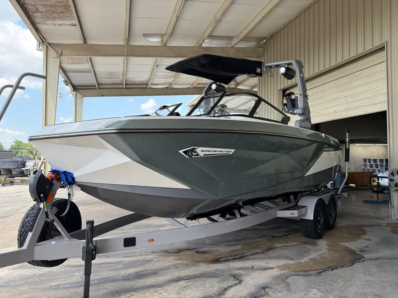 Slide: The Image of 2022 Nautique Super Air G23 boat on trailer in covered storage area. - 2