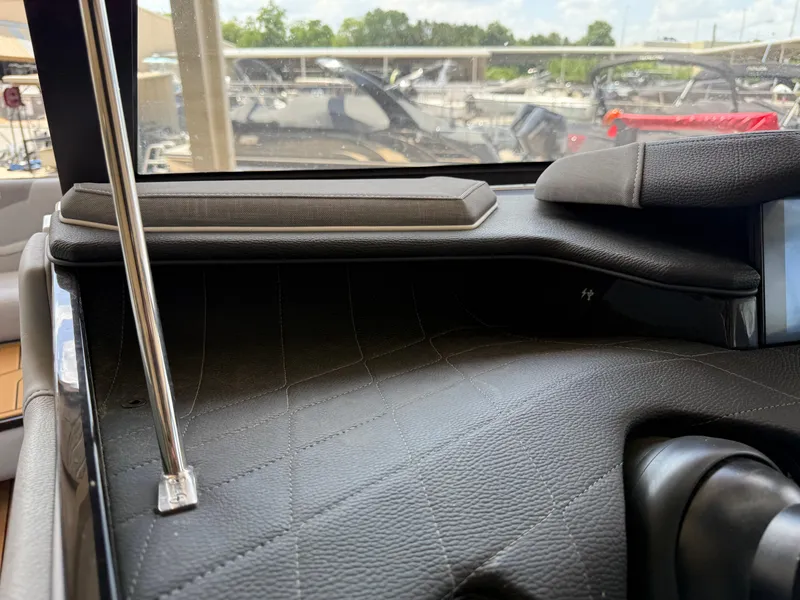 Slide: The Image of Interior view of 2022 Nautique Super Air G23 boat dashboard with leather detailing. - 22