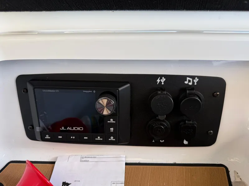 Slide: The Image of JL Audio system panel on 2022 Nautique Super Air G23 boat dashboard. - 23