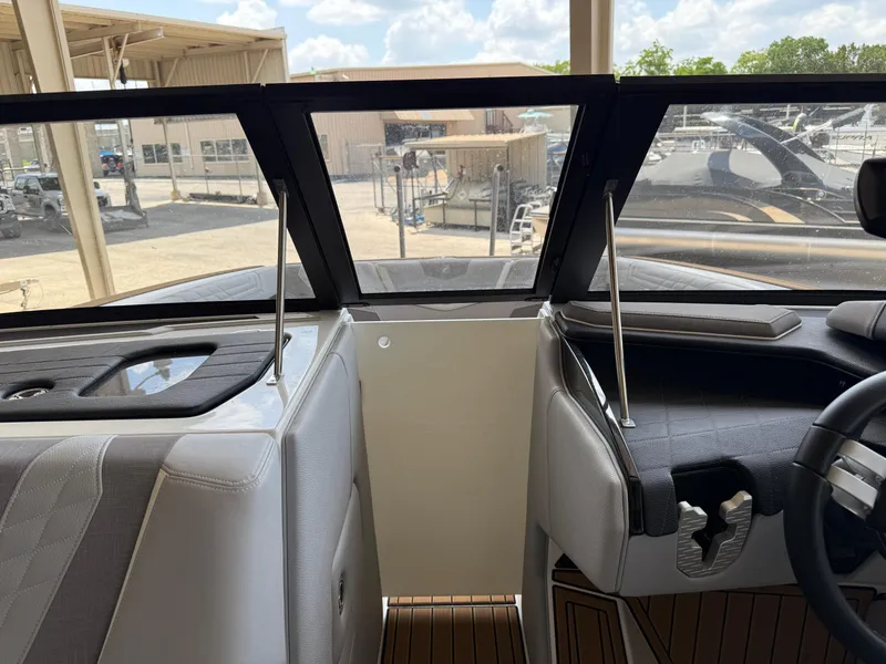 Slide: The Image of 2022 Nautique Super Air G23 boat interior with windshield and dashboard view. - 25