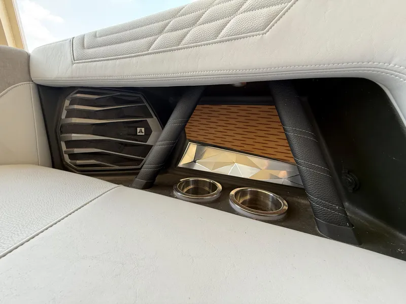 Slide: The Image of 2022 Nautique Super Air G23 interior with speaker and cup holders. - 27