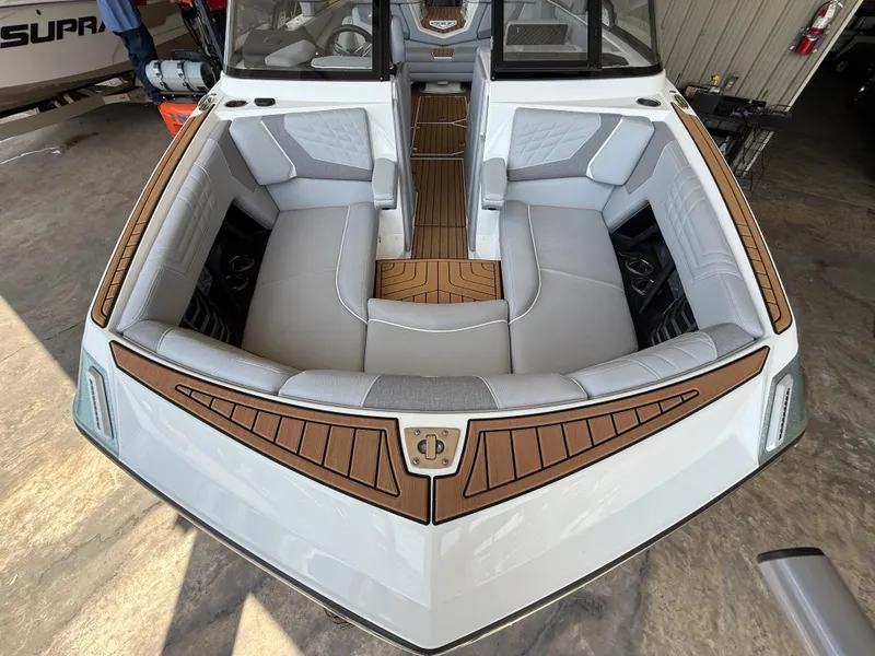 Slide: The Image of 2022 Nautique Super Air G23 boat interior with gray seating and brown accents. - 29