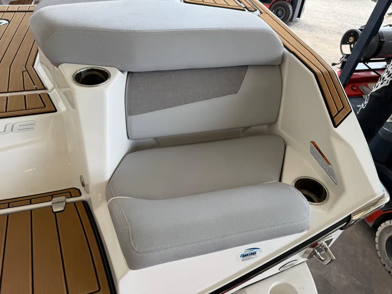 Slide: The Image of 2022 Nautique Super Air G23 boat seating with gray cushions and cup holders. - 4