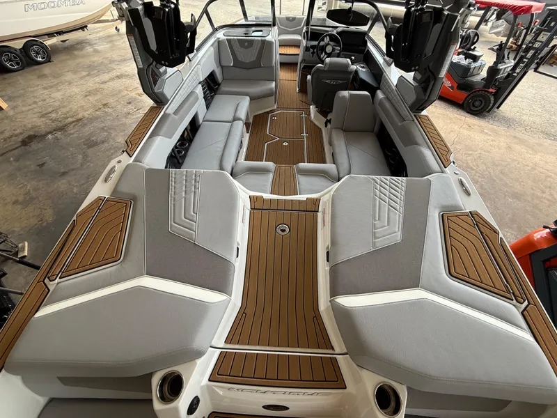 Slide: The Image of 2022 Nautique Super Air G23 interior with gray seating and teak flooring. - 5