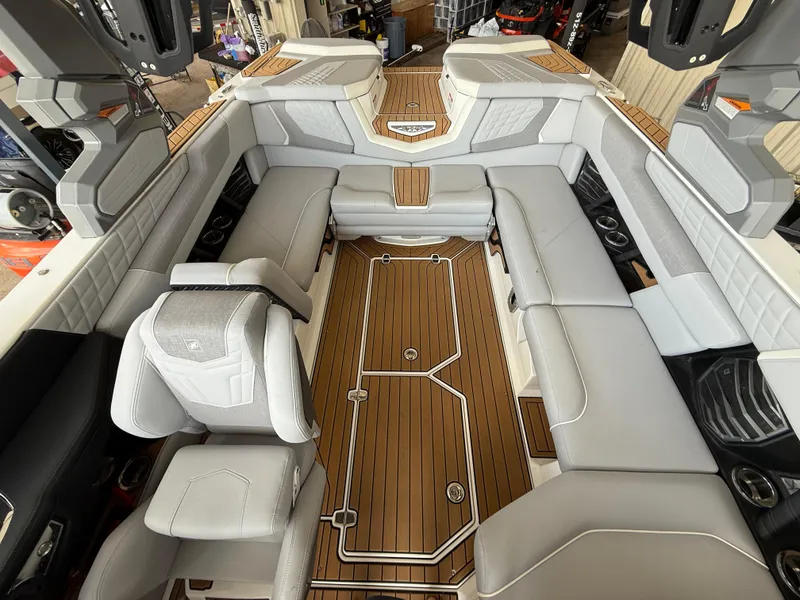 Slide: The Image of 2022 Nautique Super Air G23 interior with luxurious seating and teak flooring. - 6