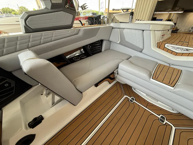Slide: The Image of 2022 Nautique Super Air G23 interior with luxurious seating and teak-style flooring. - 7
