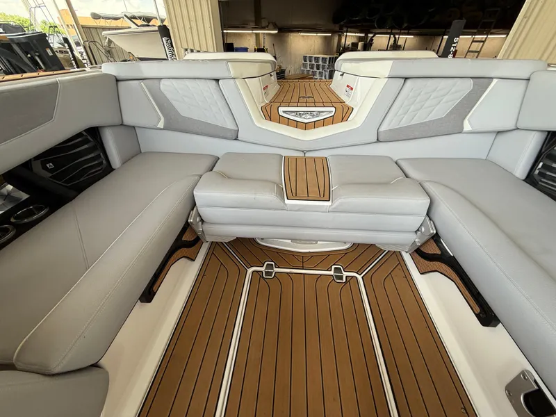 Slide: The Image of 2022 Nautique Super Air G23 interior with luxurious seating and teak-style flooring. - 8