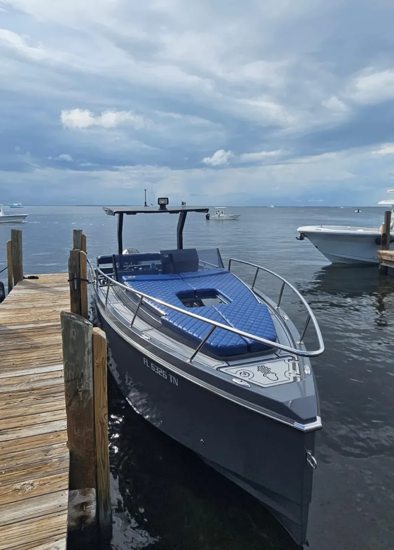 Slide: The Image of 2023 Argonaut 260 boat docked by the pier under cloudy skies. - 8