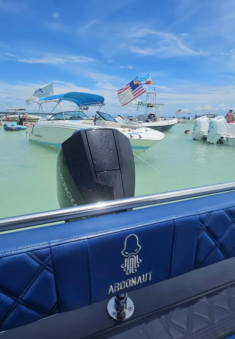 Slide: The Image of 2023 Argonaut 260 boat on clear water, surrounded by other boats under a blue sky. - 9