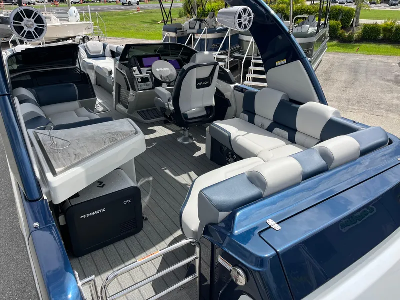 Slide: The Image of 2025 Avalon 2785 Excalibur Carbon Series boat interior with luxury seating and advanced controls. - 47