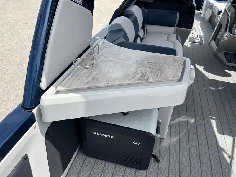 Slide: The Image of Interior of 2025 Avalon 2785 Excalibur boat with table and Dometic CFX cooler. - 49