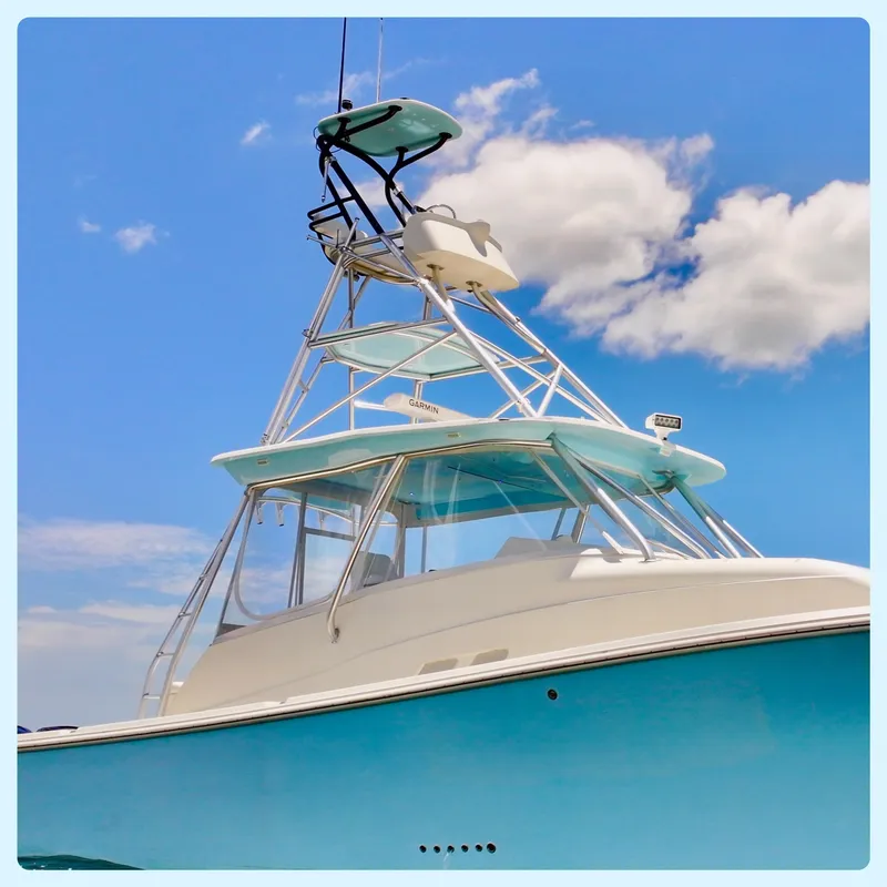 Slide: The Image of 2016 SeaVee 430 Fish Around boat against a bright blue sky with clouds. - 12