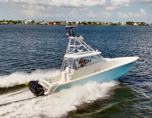 Slide: The Image of 2016 SeaVee 430 Fish Around boat cruising on open water, showcasing sleek design and powerful engines. - 2