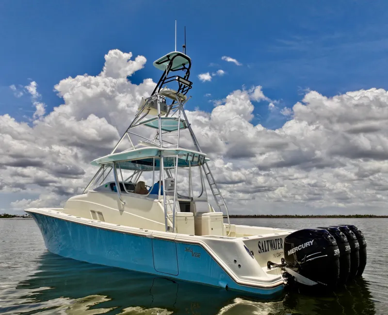 Slide: The Image of 2016 SeaVee 430 Fish Around boat with tower, on calm water under cloudy sky. - 24