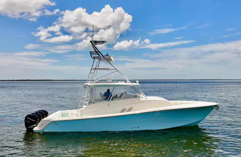 Slide: The Image of 2016 SeaVee 430 Fish Around boat on calm water under a blue sky. - 27
