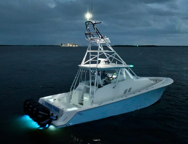 Slide: The Image of 2016 SeaVee 430 Fish Around boat illuminated on dark waters at dusk. - 28
