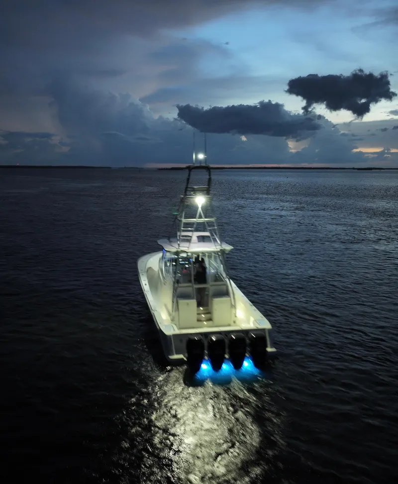 Slide: The Image of 2016 SeaVee 430 Fish Around boat illuminated on calm waters at dusk. - 29