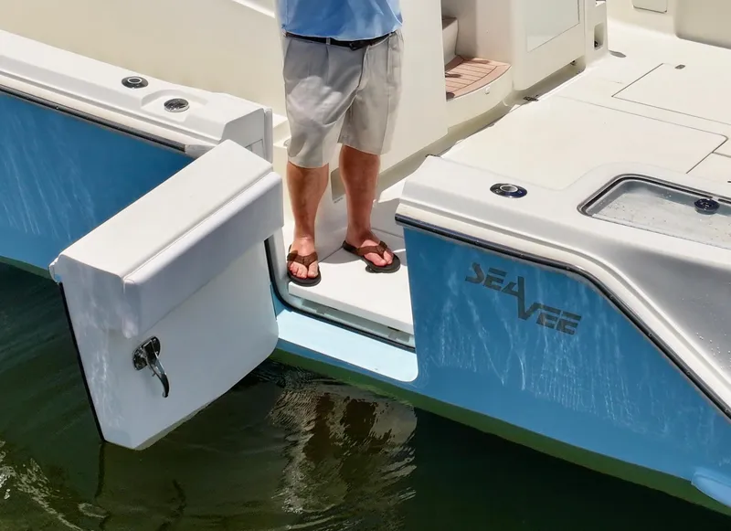 Slide: The Image of 2016 SeaVee 430 Fish Around boat with open side door, person standing on deck. - 31