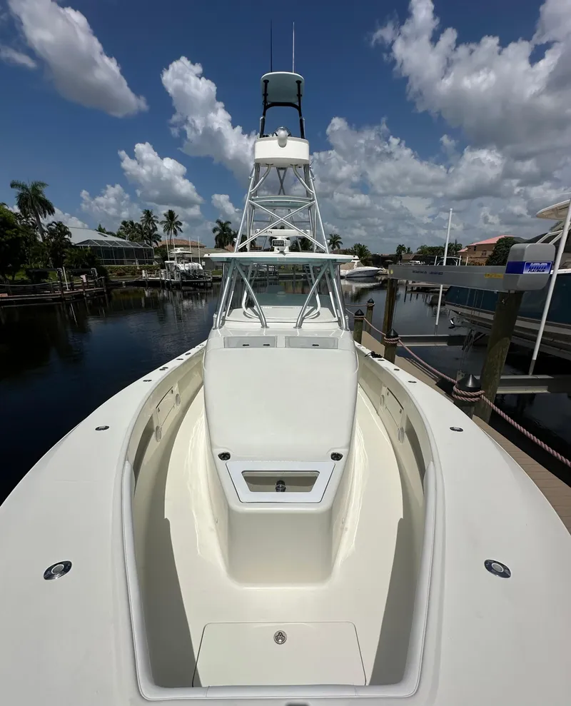 Slide: The Image of 2016 SeaVee 430 Fish Around boat docked under a clear blue sky. - 44