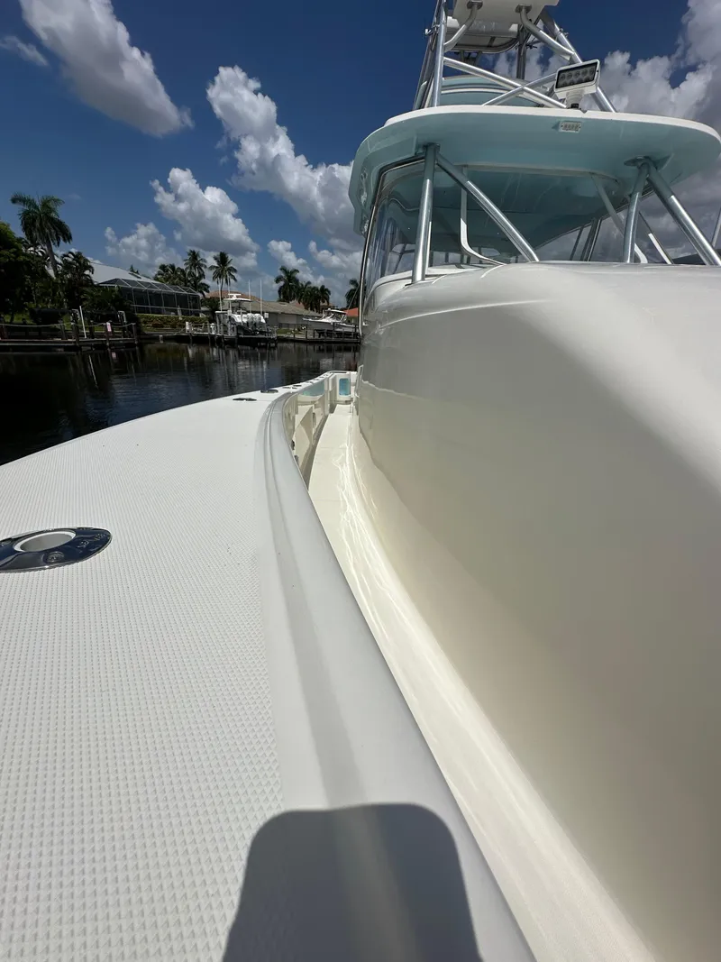 Slide: The Image of 2016 SeaVee 430 Fish Around boat docked under a clear blue sky. - 47