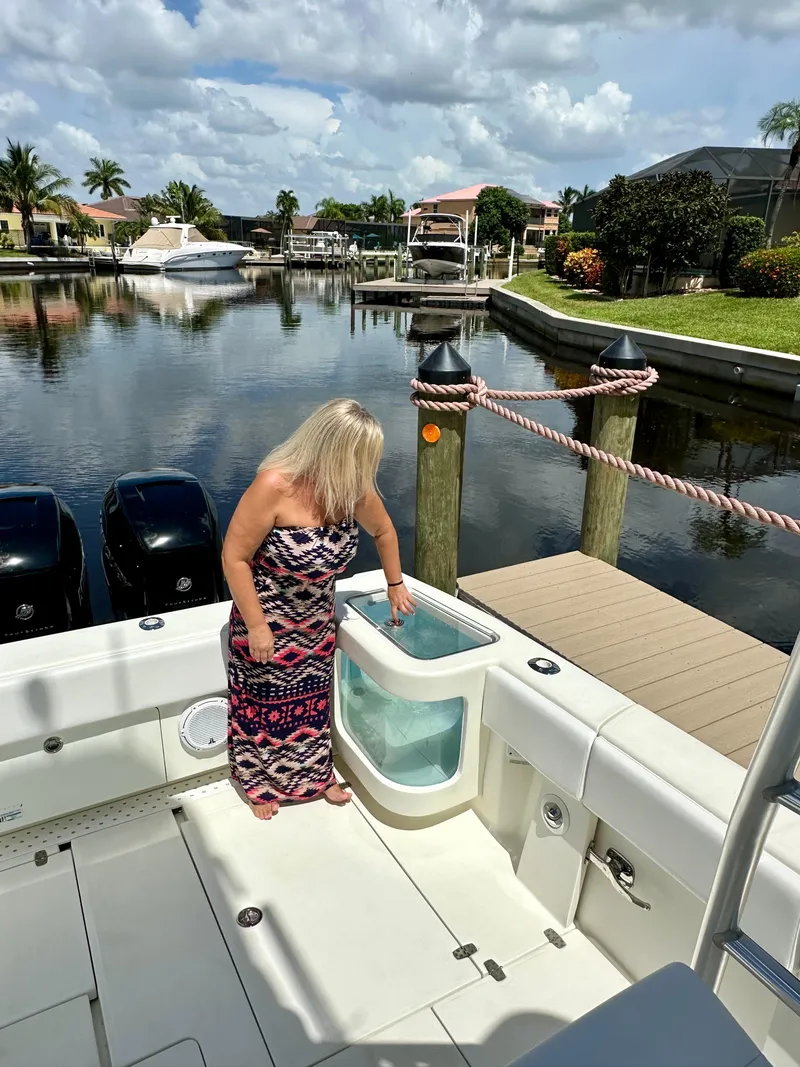 Slide: The Image of Woman on 2016 SeaVee 430 Fish Around boat by dock, sunny day, calm water. - 48