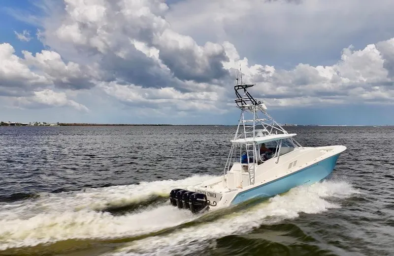 Slide: The Image of 2016 SeaVee 430 Fish Around boat cruising on open water under cloudy skies. - 5