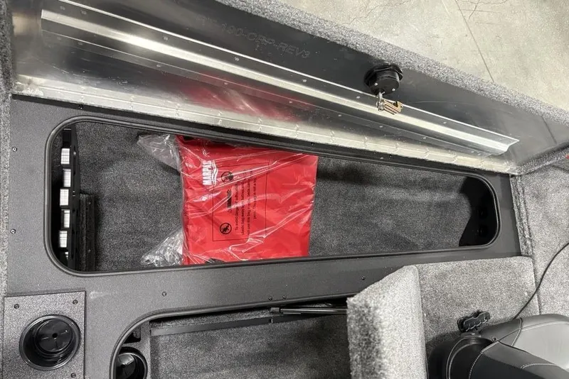 Slide: The Image of Storage compartment of 2025 Tracker Pro Team™ 190 boat with red safety bag. - 11