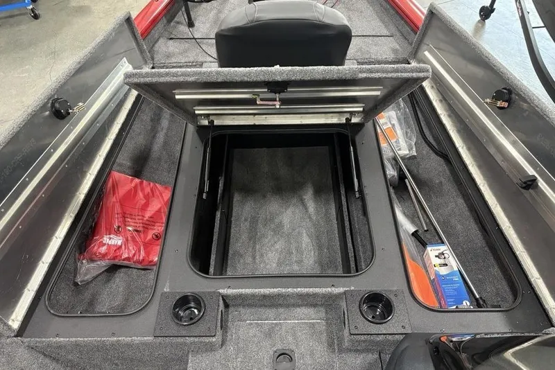 Slide: The Image of 2025 Tracker Pro Team™ 190 boat interior with open storage compartment and accessories. - 13