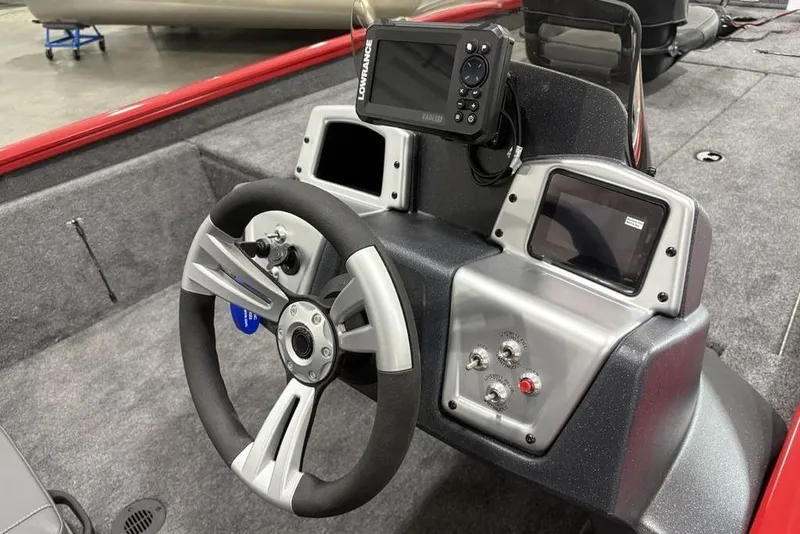 Slide: The Image of 2025 Tracker Pro Team™ 190 boat dashboard with steering wheel and electronic controls. - 15
