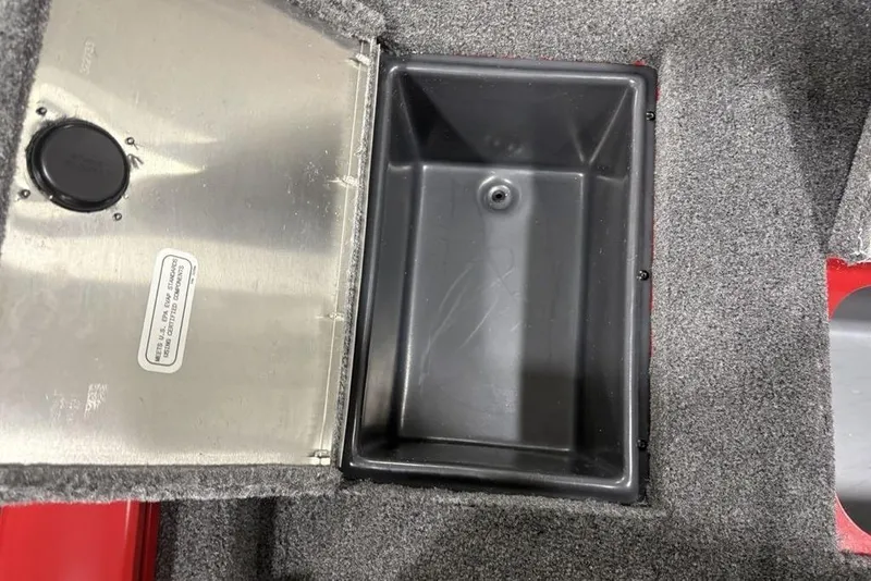 Slide: The Image of Open storage compartment in 2025 Tracker Pro Team™ 190 boat, featuring carpeted interior. - 24