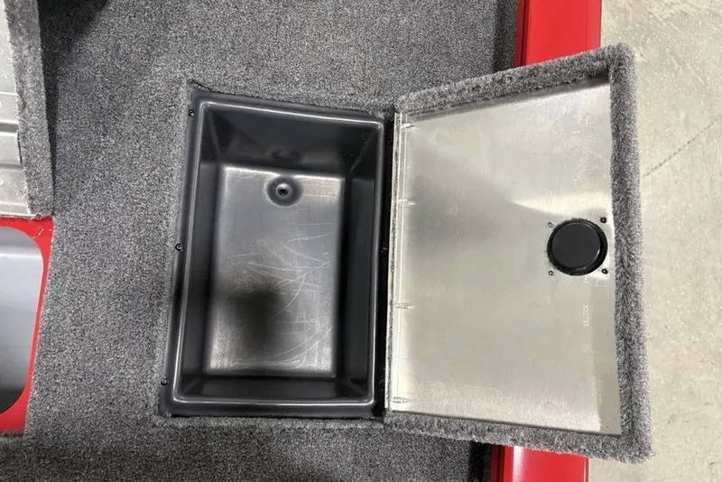 Slide: The Image of Open storage compartment in 2025 Tracker Pro Team™ 190 boat, featuring carpeted interior and metal lid. - 29