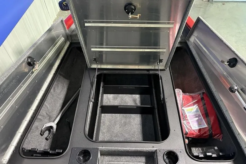 Slide: The Image of 2026 Tracker Pro Team 190 boat storage compartments with tools and safety gear. - 32