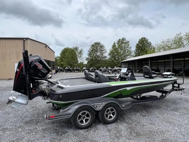 The Image of 2024 Nitro Z21 XL boat with trailer, parked outdoors on gravel. - 1