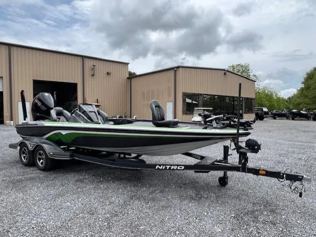 Slide: The Image of 2024 Nitro Z21 XL boat on trailer, parked outside industrial buildings. - 4